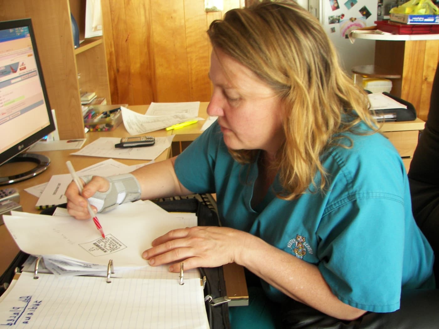 Dr. Tess Peavy writing at her desk during the Neuter Scooter era