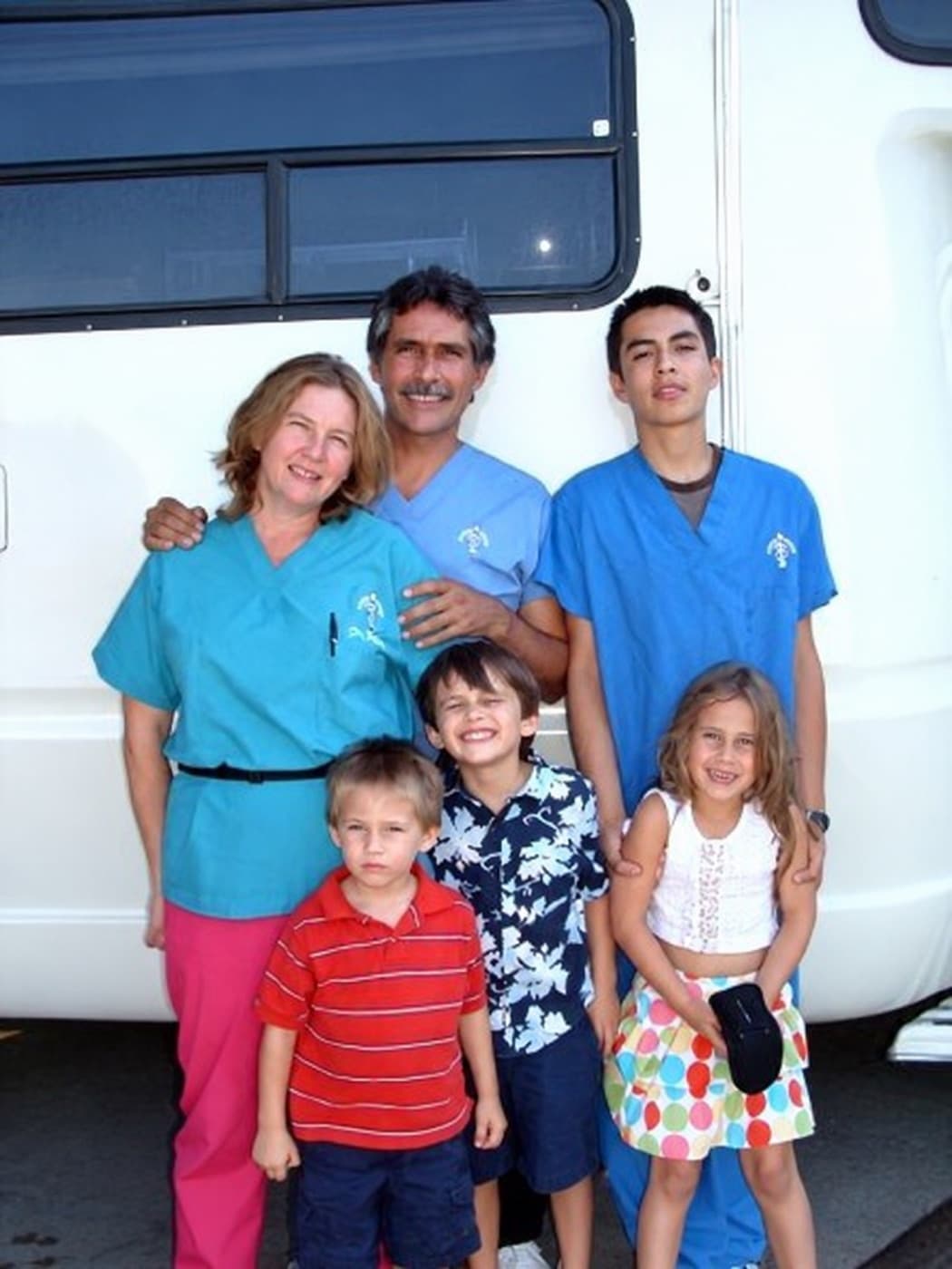 Dr. Tess Peavy and her family beside the Neuter Scooter mobile unit